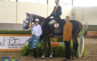Cooper Dean, aboard Kori d’Oro with trainer Patricia Griffith, is presented as winner of the Region 1 ASPCA/NHSAA Maclay Championship by Mason Phelps, representing the CP National Horse Show. Photo by Jump Media